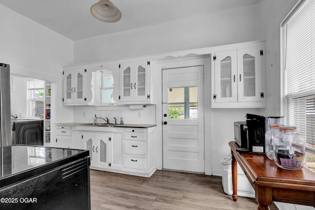 1815 S Empire Ave, Joplin, MO 64801 - kitchen featuring glass insert cabinets, white cabinetry, healthy amount of natural light, and a sink