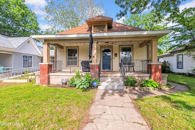 1815 S Empire Ave, Joplin, MO 64801 - view of front of property featuring covered porch, a front yard, and a shingled roof