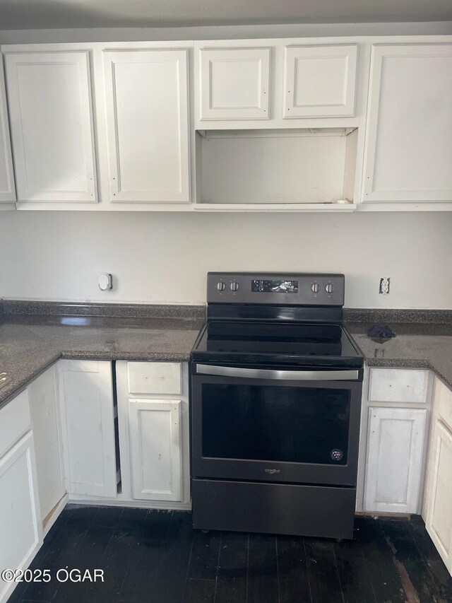 811 N Elloitt St, Webb City, MO 64870 - kitchen with electric range oven, white cabinetry, and dark countertops