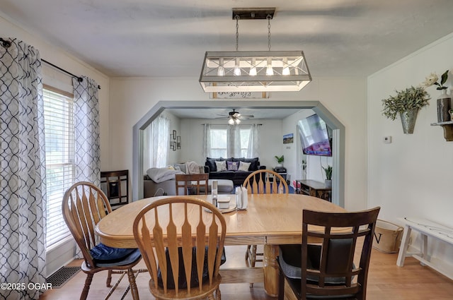 1712 E Broadway St, Joplin, MO 64801 - dining area with light wood-style floors, arched walkways, and ceiling fan