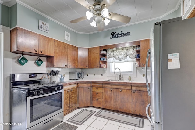 1712 E Broadway St, Joplin, MO 64801 - kitchen featuring appliances with stainless steel finishes, a sink, crown molding, brown cabinetry, and a ceiling fan
