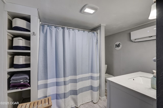 1712 E Broadway St, Joplin, MO 64801 - bathroom with a wall mounted air conditioner, wood finished floors, vanity, curtained shower, and toilet