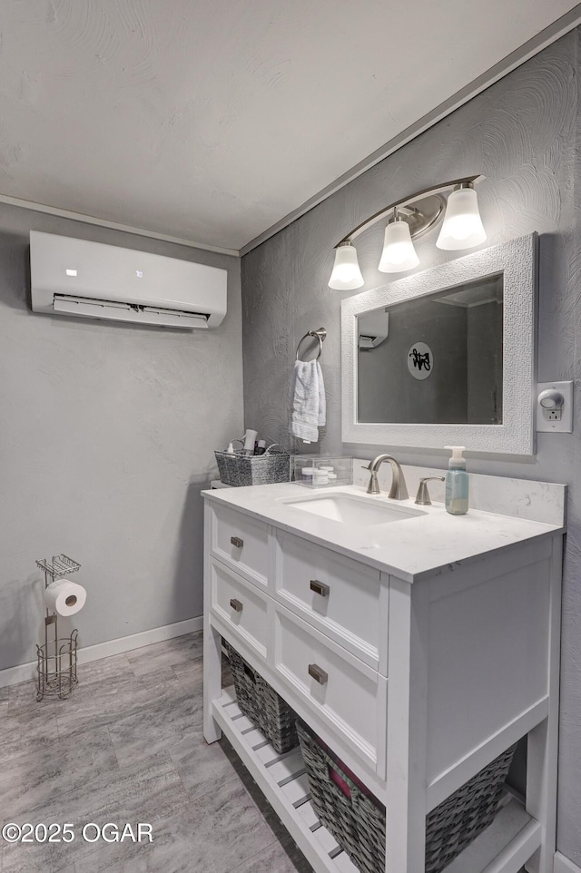 1712 E Broadway St, Joplin, MO 64801 - bathroom featuring a wall mounted air conditioner, vanity, and baseboards