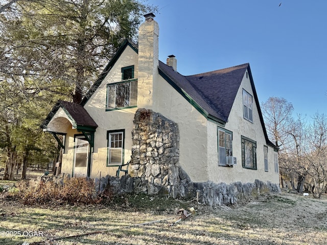 501 Saginaw Rd, Joplin, MO 64804 - view of property exterior with roof with shingles, stucco siding, a chimney, and cooling unit