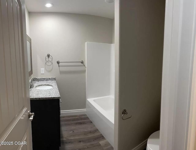 1403 E Valley St, Joplin, MO 64801 - bathroom with vanity, toilet, wood finished floors, recessed lighting, and baseboards