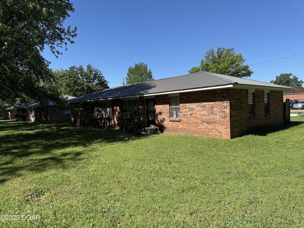 1822-1826 Maple St, Seneca, MO 64865 - back of house with a lawn and brick siding