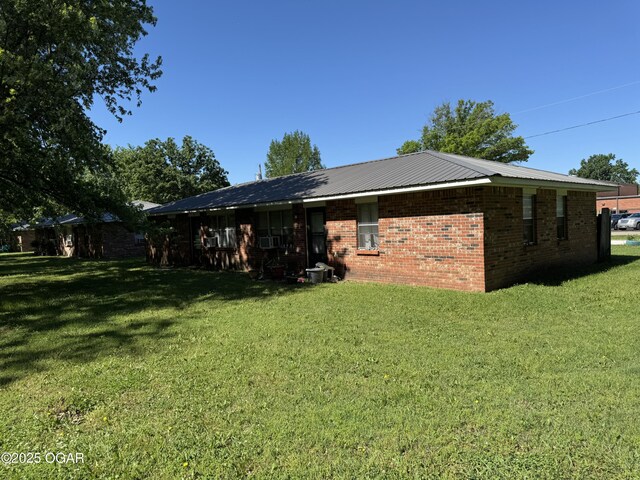 1822-1826 Maple St, Seneca, MO 64865 - back of house with a lawn and brick siding