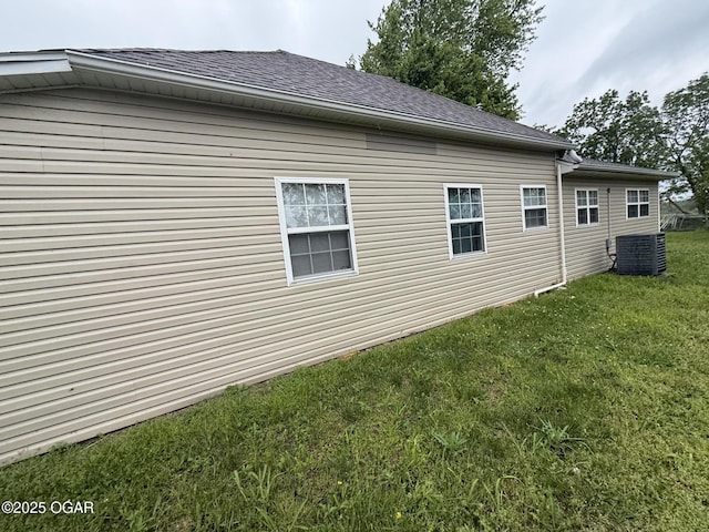304 Market St, Wentworth, MO 64873 - view of property exterior featuring a yard, a shingled roof, and central AC unit