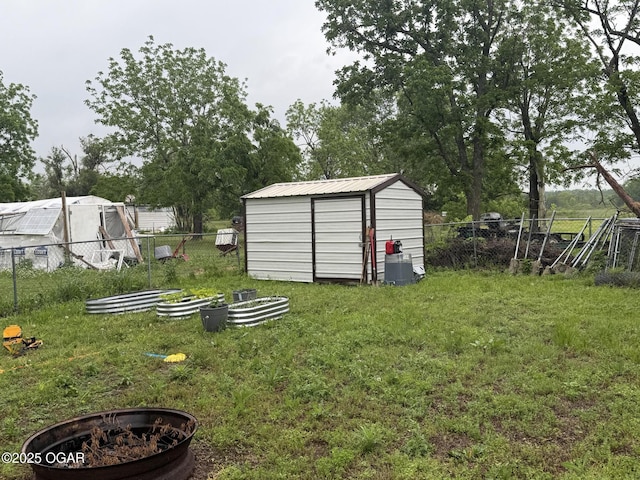 304 Market St, Wentworth, MO 64873 - view of yard with a storage unit, an outdoor fire pit, and an outdoor structure