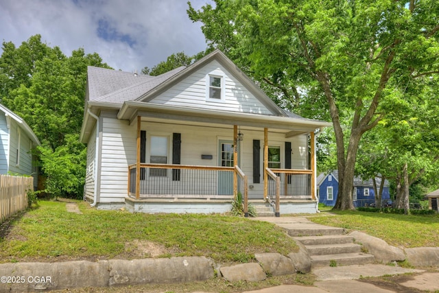328 N Connor Ave, Joplin, MO 64801 - bungalow-style home featuring covered porch, roof with shingles, and a front yard