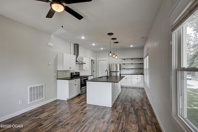 328 N Connor Ave, Joplin, MO 64801 - kitchen with stainless steel appliances, wall chimney exhaust hood, dark countertops, dark wood-type flooring, and tasteful backsplash