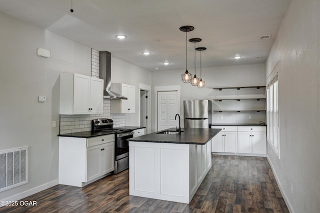 328 N Connor Ave, Joplin, MO 64801 - kitchen featuring appliances with stainless steel finishes, wall chimney range hood, a sink, dark countertops, and dark wood-style flooring