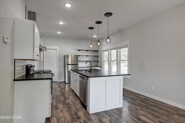 328 N Connor Ave, Joplin, MO 64801 - kitchen with dark countertops, a sink, appliances with stainless steel finishes, baseboards, and recessed lighting