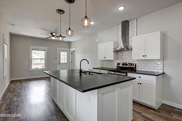 328 N Connor Ave, Joplin, MO 64801 - kitchen featuring a sink, stainless steel electric stove, wall chimney range hood, dark countertops, and a ceiling fan