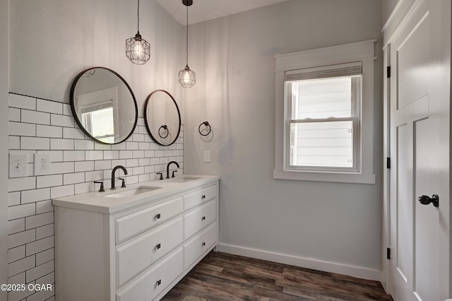 328 N Connor Ave, Joplin, MO 64801 - bathroom featuring wood finished floors, double vanity, tasteful backsplash, and baseboards