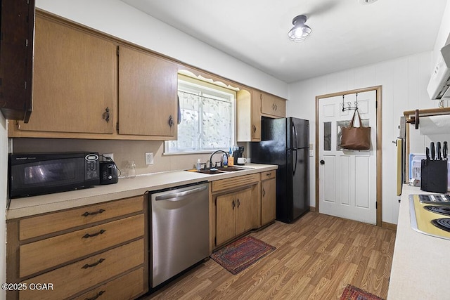 103 E Mockingbird Ln, Crane, MO 65633 - kitchen featuring black appliances, a sink, light wood-type flooring, and light countertops