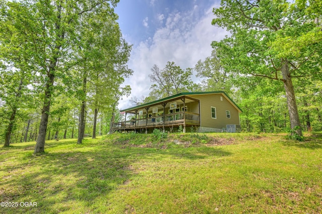 22351 S 672nd Rd, Wyandotte, OK 74370 - view of green lawn featuring central air condition unit and a wooden deck