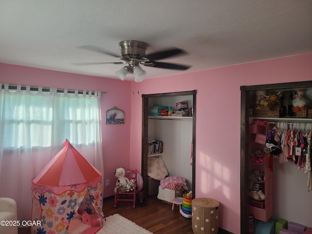511 3rd St, Mccune, KS 66753 - bedroom with wood finished floors, ceiling fan, and multiple closets