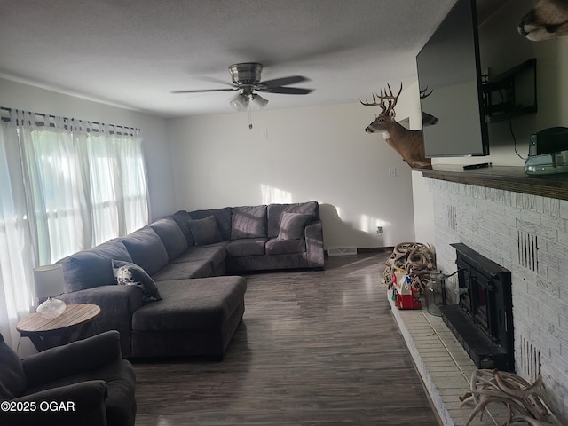 511 3rd St, Mccune, KS 66753 - living room featuring dark wood-type flooring, a ceiling fan, and baseboards