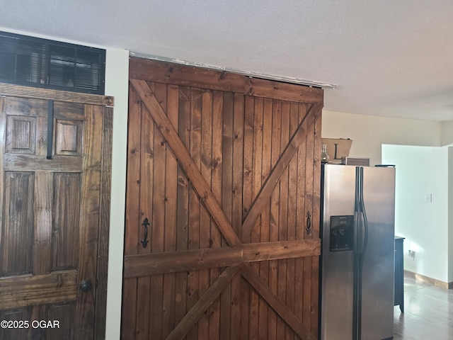 511 3rd St, Mccune, KS 66753 - detailed view of stainless steel fridge with ice dispenser and a barn door