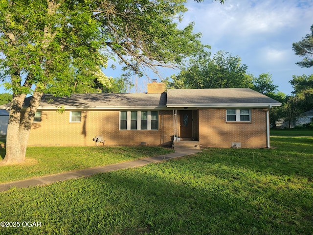 511 3rd St, Mccune, KS 66753 - ranch-style house featuring a front yard, brick siding, and a chimney