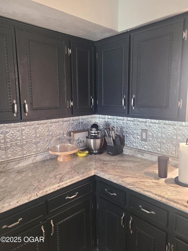 511 3rd St, Mccune, KS 66753 - kitchen featuring backsplash and dark cabinets