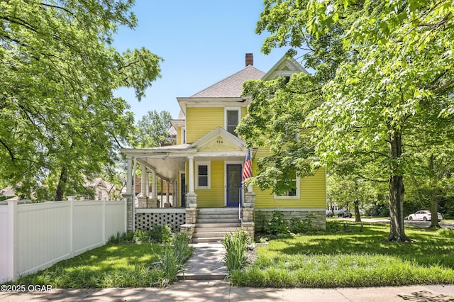 524 W 5th St, Joplin, MO 64801 - american foursquare style home featuring covered porch and a chimney