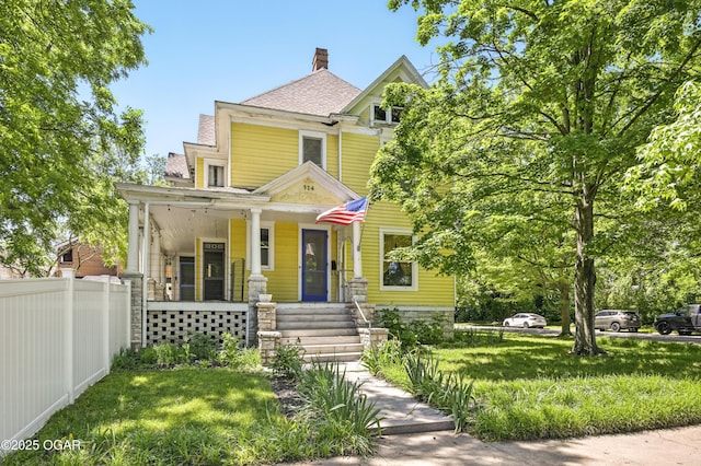 524 W 5th St, Joplin, MO 64801 - victorian house with a porch, a chimney, and a shingled roof