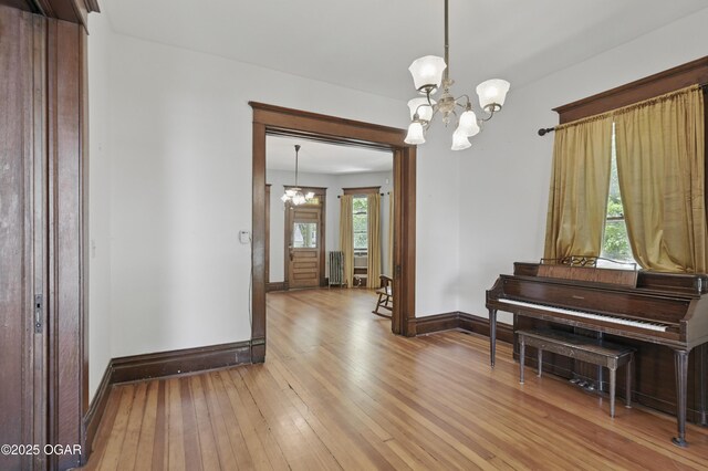 524 W 5th St, Joplin, MO 64801 - dining room featuring a chandelier, wood-type flooring, and baseboards