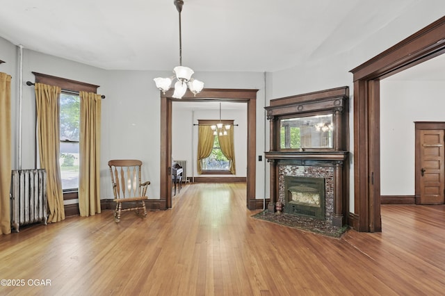 524 W 5th St, Joplin, MO 64801 - living room with a chandelier, wood finished floors, a fireplace, and baseboards