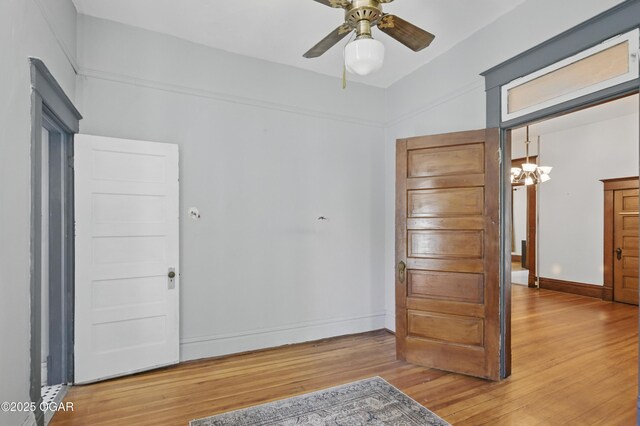 524 W 5th St, Joplin, MO 64801 - bedroom featuring wood finished floors, baseboards, and a ceiling fan