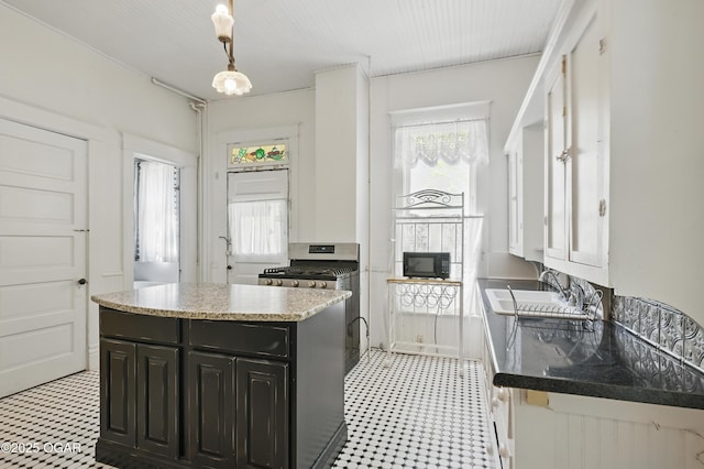 524 W 5th St, Joplin, MO 64801 - kitchen with light flooring, a sink, dark cabinets, and black microwave