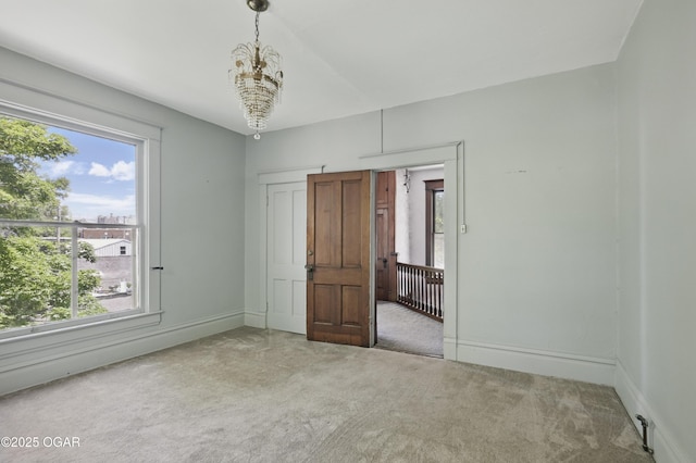524 W 5th St, Joplin, MO 64801 - unfurnished bedroom featuring carpet floors, multiple windows, and a chandelier