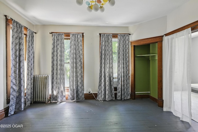 524 W 5th St, Joplin, MO 64801 - unfurnished bedroom with radiator heating unit and hardwood / wood-style flooring