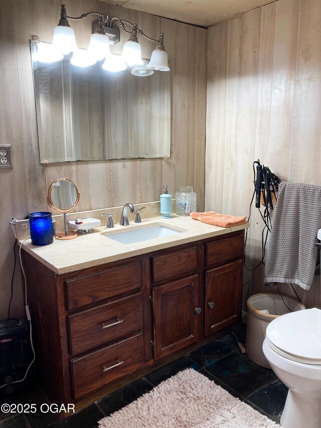 1017 E Broadway St, Joplin, MO 64801 - half bathroom with vanity, toilet, and wood walls