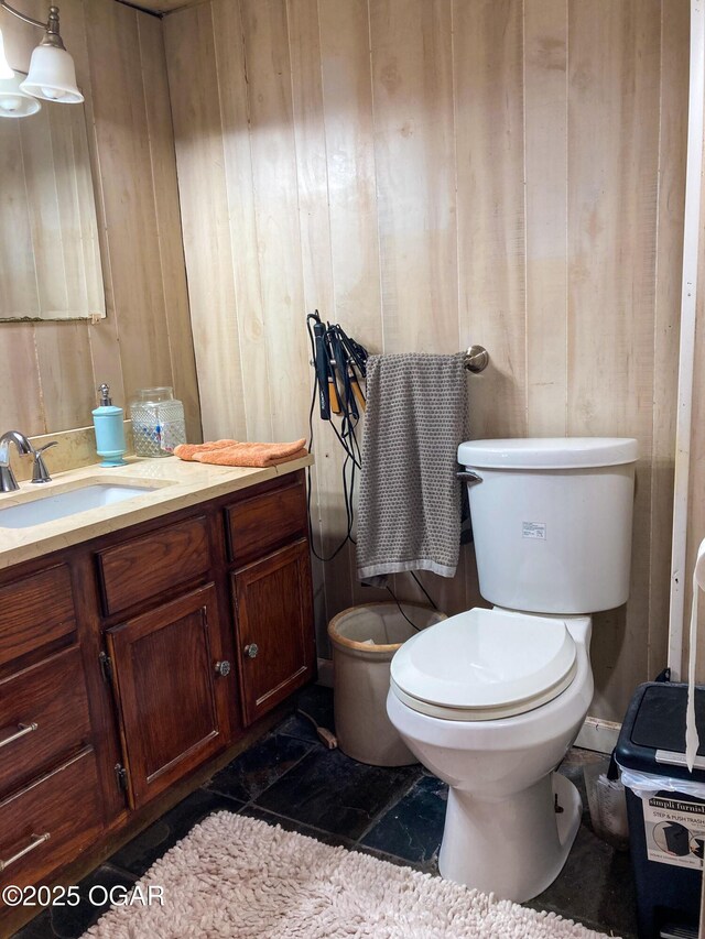 1017 E Broadway St, Joplin, MO 64801 - bathroom with toilet, vanity, and wooden walls