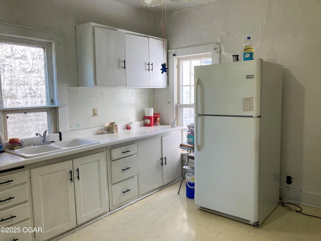 1017 E Broadway St, Joplin, MO 64801 - kitchen featuring freestanding refrigerator, a sink, light countertops, and white cabinets