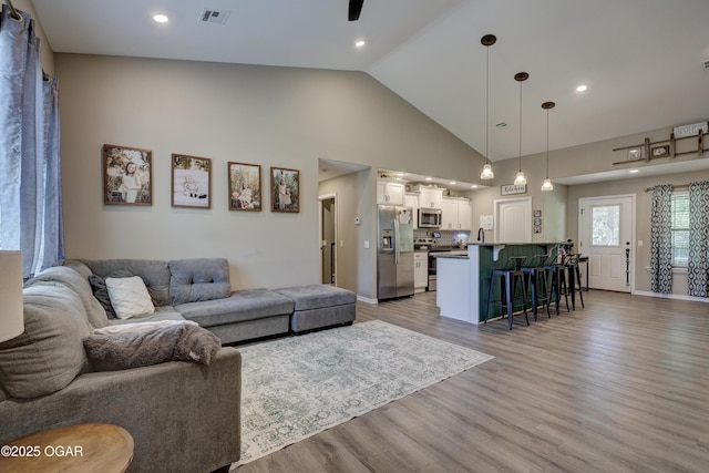 2615 E Xenia St, Joplin, MO 64801 - living room featuring light wood finished floors, high vaulted ceiling, recessed lighting, and baseboards