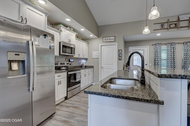 2615 E Xenia St, Joplin, MO 64801 - kitchen with appliances with stainless steel finishes, a sink, decorative backsplash, white cabinetry, and recessed lighting
