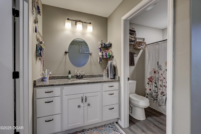 2615 E Xenia St, Joplin, MO 64801 - full bathroom featuring vanity, toilet, wood finished floors, and a shower with curtain