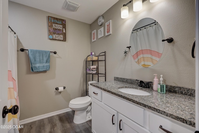 2615 E Xenia St, Joplin, MO 64801 - bathroom with wood finished floors, vanity, toilet, baseboards, and a shower with curtain