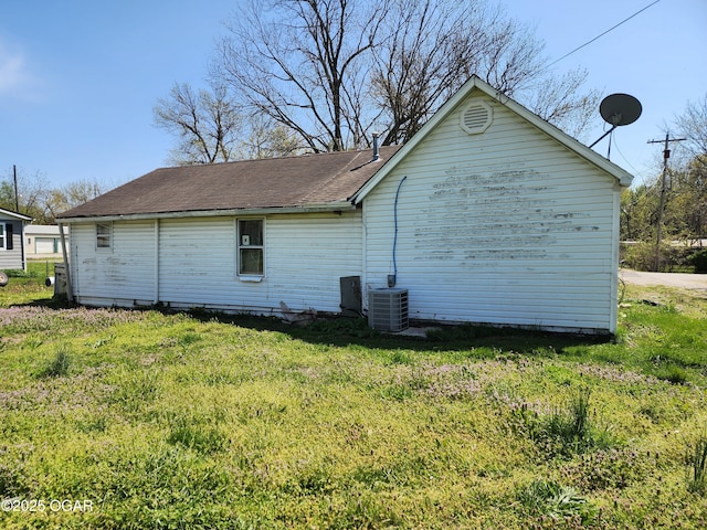 404 E 14th St, Lamar, MO 64759 - view of property exterior with a lawn and central air condition unit