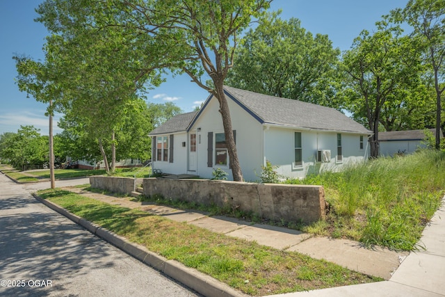 201 S Tom, Webb City, MO 64870 - view of front facade with stucco siding, roof with shingles, and cooling unit