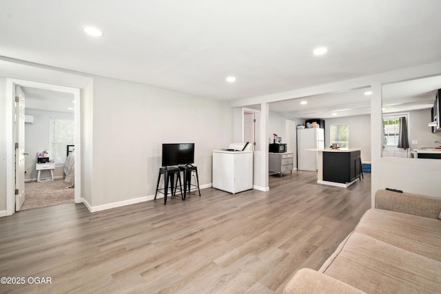 201 S Tom, Webb City, MO 64870 - living room with washer / dryer, recessed lighting, plenty of natural light, light wood-type flooring, and baseboards