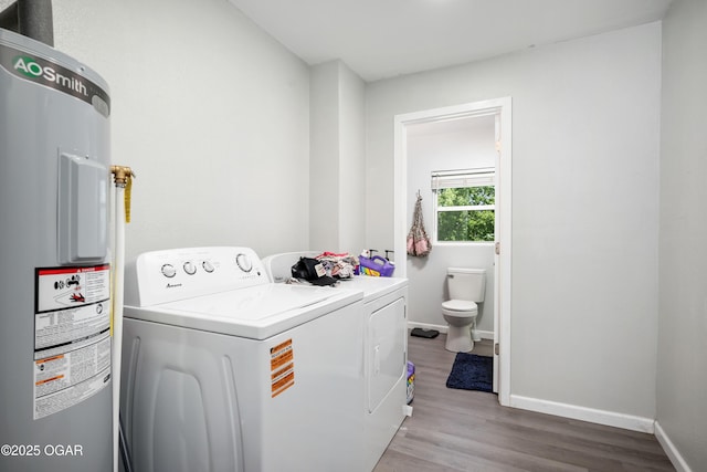 201 S Tom, Webb City, MO 64870 - laundry area featuring electric water heater, washer and clothes dryer, wood finished floors, and baseboards