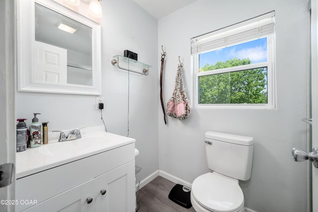 201 S Tom, Webb City, MO 64870 - bathroom featuring toilet, baseboards, vanity, and wood finished floors