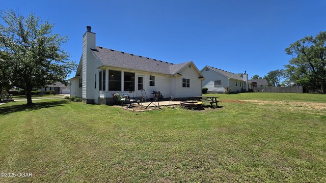 505 W Gault St, Carl Junction, MO 64834 - back of property with an outdoor fire pit, a chimney, a patio area, and roof with shingles