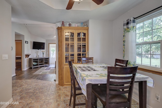 505 W Gault St, Carl Junction, MO 64834 - dining area featuring a ceiling fan, light stone finish flooring, baseboards, and lofted ceiling