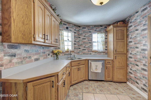 505 W Gault St, Carl Junction, MO 64834 - kitchen with dishwasher, a sink, light countertops, a textured ceiling, and brick wall
