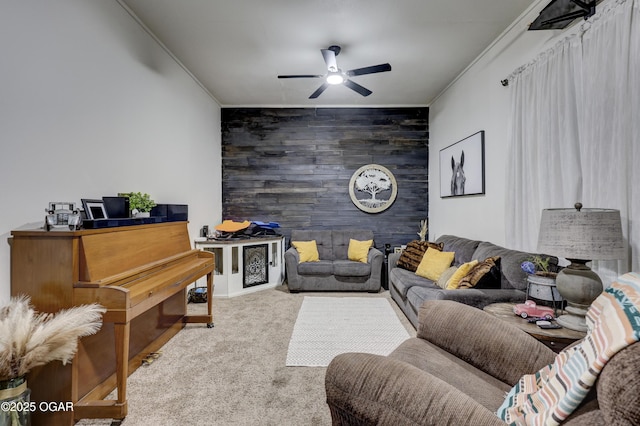 2408 Lincoln Ave, Baxter Springs, KS 66713 - carpeted living area with an accent wall, wood walls, a ceiling fan, and crown molding